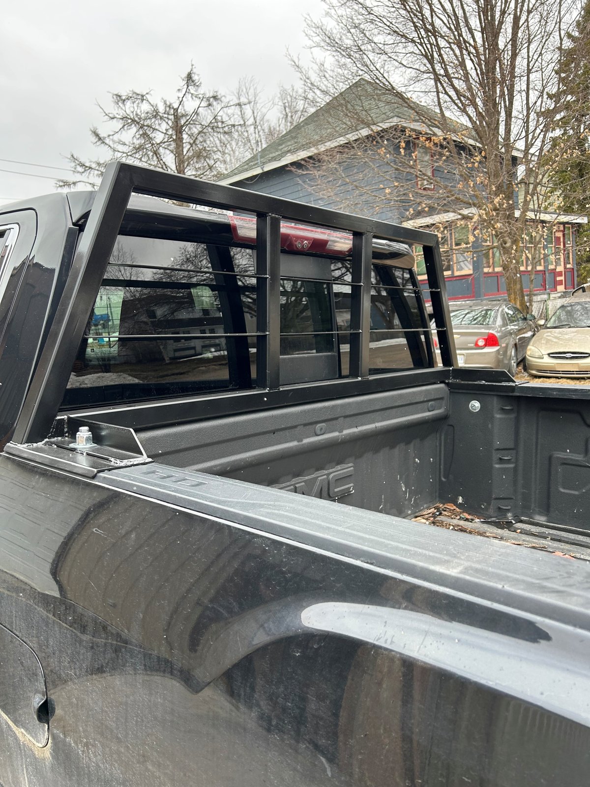 Custom steel headache rack with window guard, built and installed on a GMC pickup truck by Steel River Fabrication