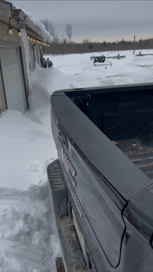 New custom steel tailgate cap installed on a GMC pickup, wide view