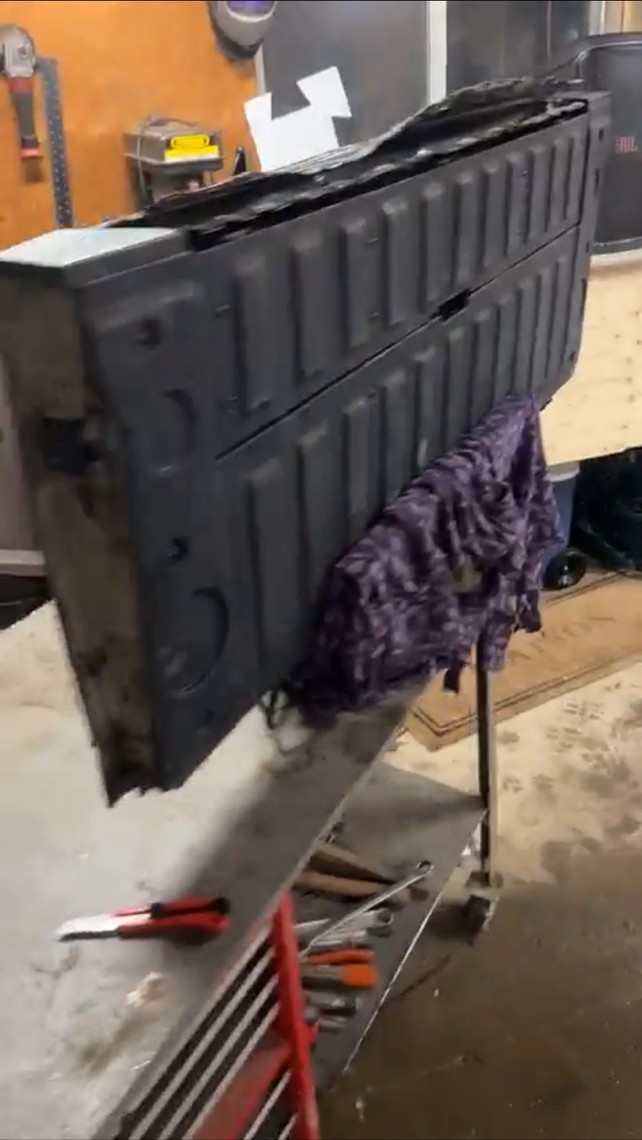 Old thin metal tailgate cap, cracked and rusted before replacement